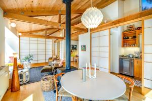 a kitchen and living room with a table and chairs at Madrone Cottage in Sea Ranch