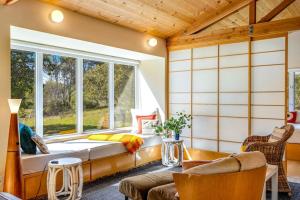 a room with a window and a couch at Madrone Cottage in Sea Ranch