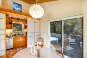 a kitchen and dining room with a table and chairs at Madrone Cottage in Sea Ranch