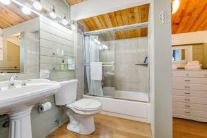 a bathroom with a toilet and a sink and a shower at Otter's Rest in Gualala +26 photos