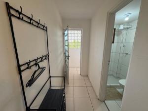 a bathroom with a walk in shower and a mirror at SJ Suites in São José dos Pinhais