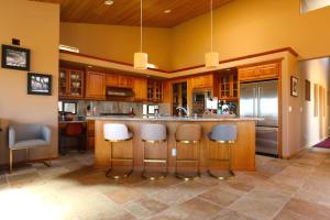 a kitchen with a island with bar stools at Da Yaya House in Sea Ranch