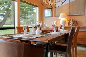 a dining room table with wine glasses on it at Da Yaya House in Sea Ranch
