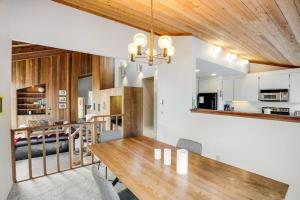 a dining room and kitchen with a wooden table at Greencroft Meadows in Sea Ranch