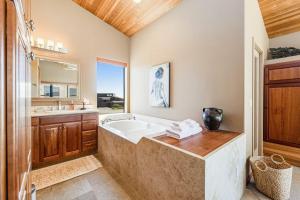 a large bathroom with a tub and a sink at Da Yaya House in Sea Ranch