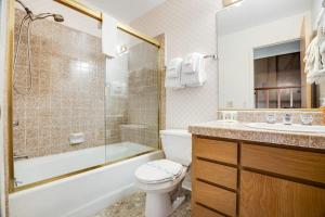 a bathroom with a toilet and a shower and a sink at Greencroft Meadows in Sea Ranch +15 photos