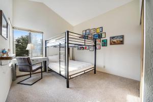 a bedroom with a bunk bed and a desk at Greencroft Meadows in Sea Ranch