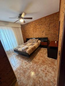 a bedroom with a bed and a ceiling fan at KyN in Cornago