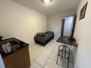 a small room with a bed in a room at SJ Suites in São José dos Pinhais +40 photos