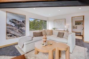 a living room with a white couch and a table at Sequoia Vista in Gualala +44 photos