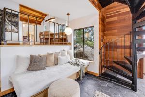 a living room with a couch and a staircase at Sequoia Vista in Gualala