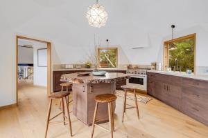a kitchen with a large island with bar stools at Sequoia Vista in Gualala