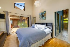 a bedroom with a large bed and a sliding glass door at SeaRenity in Sea Ranch