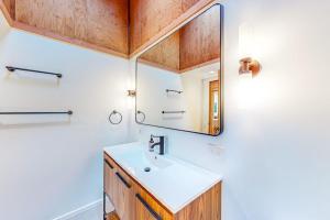 a bathroom with a sink and a mirror at Dune Drift in Sea Ranch +15 photos