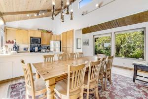 a kitchen and dining room with a wooden table and chairs at Urban Escape Compound in Sea Ranch