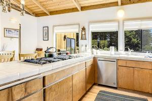 a kitchen with a stove top oven next to a sink at Urban Escape Compound in Sea Ranch