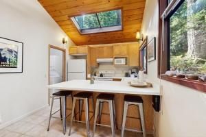 a kitchen with a large white island in a tiny house at Deep Woods Hideaway in Annapolis