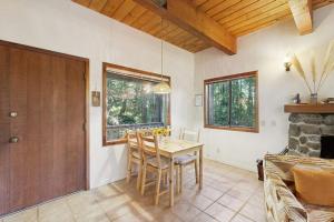 a dining room with a table and chairs and a fireplace at Deep Woods Hideaway in Annapolis