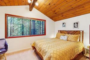 a bedroom with a bed and a large window at Deep Woods Hideaway in Annapolis