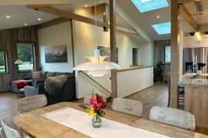a dining room and living room with a table and chairs at Coastal Calm at Sea Ranch in Sea Ranch