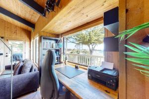 a living room with a desk and a window at Eagle's Landing - Main House & Studio in Gualala