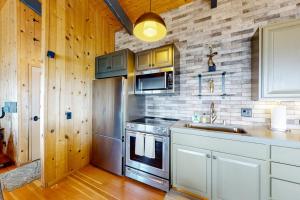 a kitchen with a stove and a sink at Eagle's Landing - Main House & Studio in Gualala +41 photos