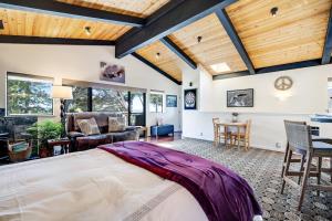 a bedroom with a large bed and a living room at Eagle's Landing - Main House & Studio in Gualala