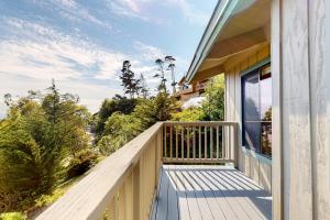 a balcony of a house with a view of trees at Eagle's Landing - Main House in Gualala