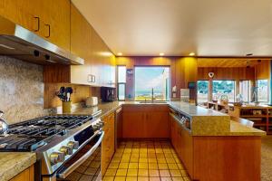a large kitchen with a stove and a large window at Touch the Tides in Sea Ranch