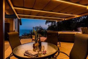 a table on a patio with a view of the ocean at Eagle's Landing - Main House in Gualala +27 photos