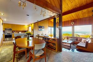 a kitchen with a wooden table and a dining room at Touch the Tides in Sea Ranch