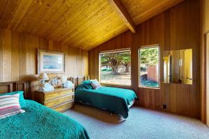 a bedroom with two beds and a window at Touch the Tides in Sea Ranch