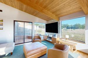 a large living room with a tv and a couch at Coffee by the Sea in Sea Ranch