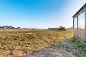 a house in the middle of a field at Coffee by the Sea in Sea Ranch