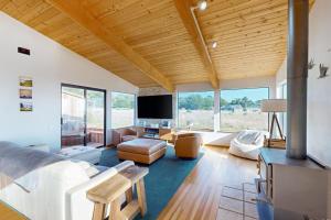 a living room with a bed and a tv at Coffee by the Sea in Sea Ranch