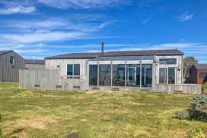 a house with glass doors on a yard at Elizabeth Dane in Sea Ranch