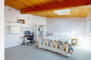 a bedroom with a bed and a desk with a computer at Elizabeth Dane in Sea Ranch