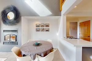 a dining room with a table and a kitchen at Blue Mermaid in Sea Ranch