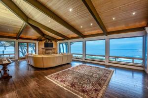 a large living room with a large couch and windows at Oceanfront Dream Hideaway in Gualala