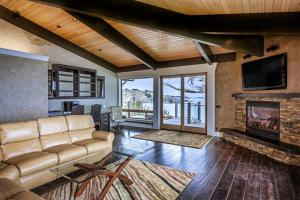 a living room with a couch and a fireplace at Oceanfront Dream Hideaway in Gualala +33 photos