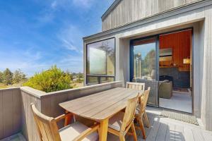 a wooden table on the balcony of a house at Timber & Tide in Sea Ranch