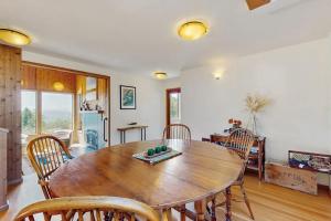 a dining room with a wooden table and chairs at Timber & Tide in Sea Ranch +24 photos