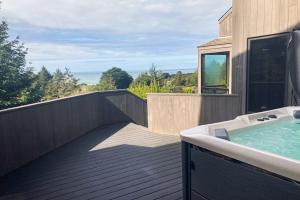 a bathroom with a bath tub on a wooden deck at Timber & Tide in Sea Ranch