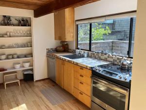 a kitchen with a stove and a sink and a window at Madrone Meadow in Sea Ranch