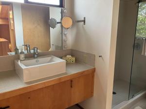 a bathroom with a sink and a mirror at Madrone Meadow in Sea Ranch +5 photos
