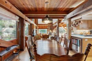 a dining room with a long table and a kitchen at Schooner in Sea Ranch