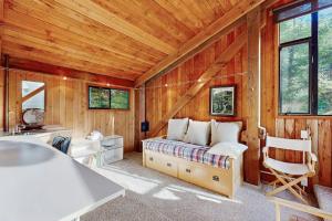 a bedroom with a bed in a room with wooden walls at Schooner in Sea Ranch +17 photos