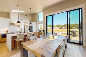a kitchen and dining room with a large wooden table at Cabañita Del Mar in Sea Ranch