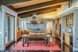 a large kitchen with a table in the middle at Oceanfront Dream Hideaway and Retreat in Gualala