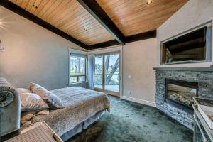 a bedroom with a bed and a fireplace at Oceanfront Dream Hideaway and Retreat in Gualala